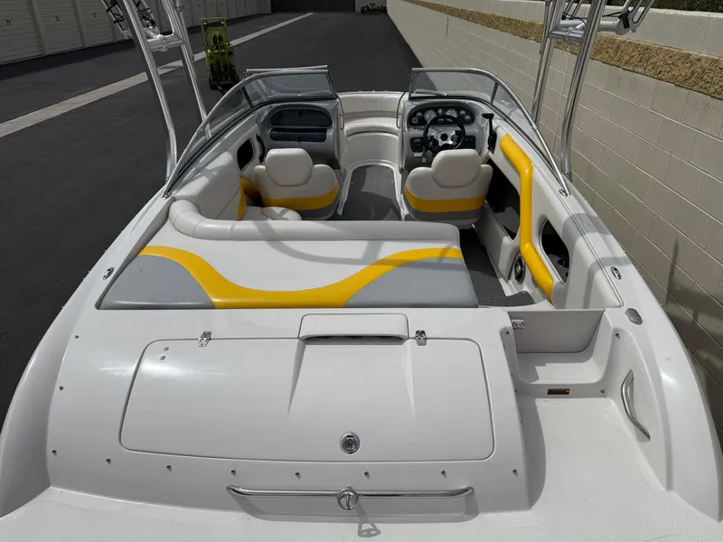 Slide: The Image of 2008 Reinell Bowrider 220LSE interior with yellow and gray seating, open cockpit view. - 21