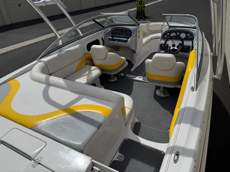 Slide: The Image of 2008 Reinell Bowrider 220LSE interior with yellow and white seating, modern dashboard, and spacious layout. - 26