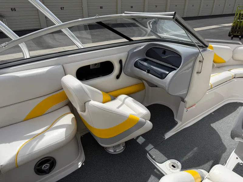 Slide: The Image of 2008 Reinell Bowrider 220LSE interior with white and yellow seating, dashboard, and storage compartments. - 27