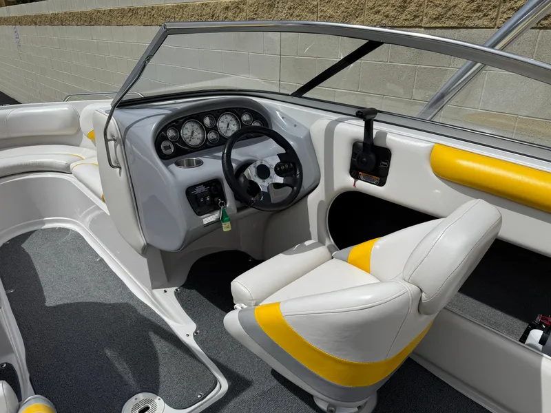 Slide: The Image of 2008 Reinell Bowrider 220LSE interior with steering wheel and yellow-accented seating. - 28