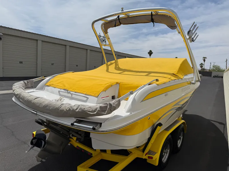 Slide: The Image of 2008 Reinell Bowrider 220LSE with yellow cover on trailer, parked near storage units. - 37