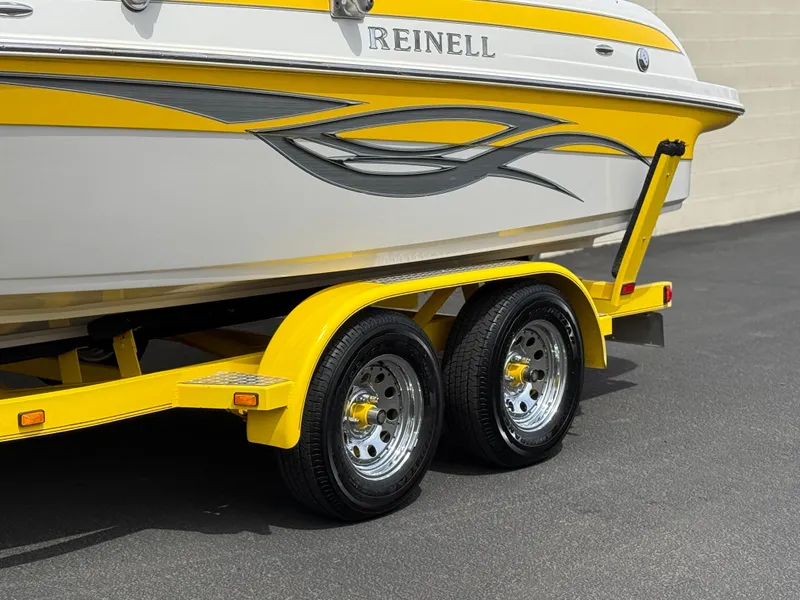 Slide: The Image of 2008 Reinell Bowrider 220LSE on yellow trailer, featuring sleek design and dual wheels. - 4
