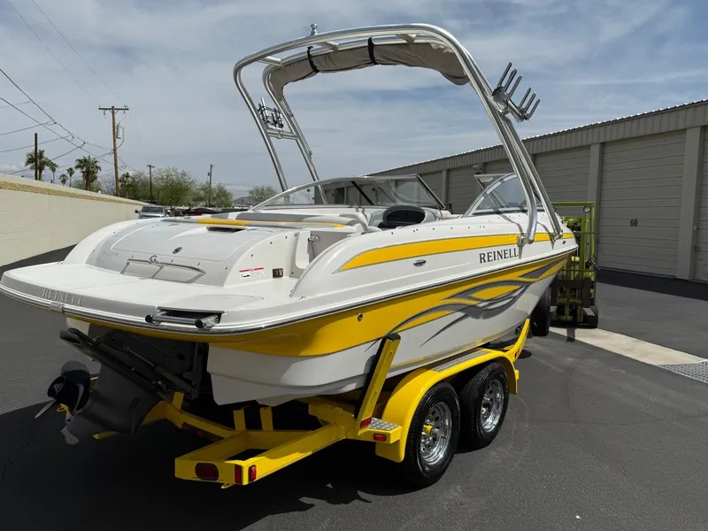 Slide: The Image of 2008 Reinell Bowrider 220LSE on trailer, yellow and white design, parked outdoors. - 42
