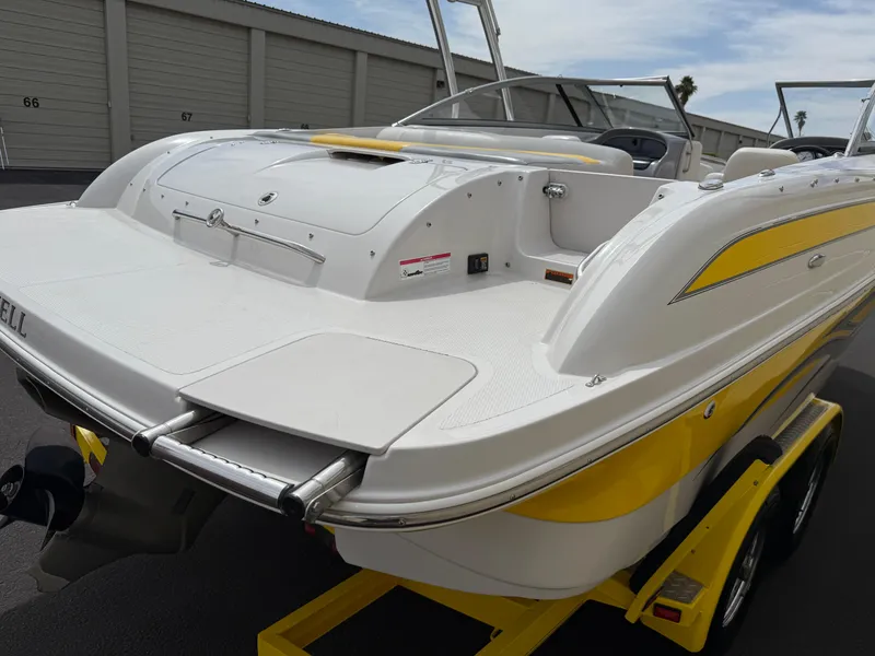 Slide: The Image of 2008 Reinell Bowrider 220LSE boat with yellow accents on a trailer. - 43