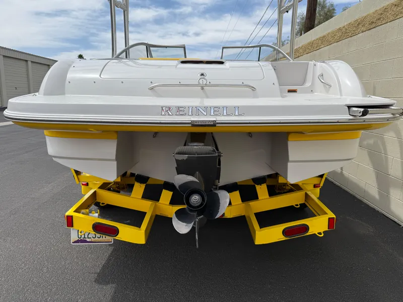 Slide: The Image of 2008 Reinell Bowrider 220LSE on yellow trailer, rear view, parked outdoors. - 7