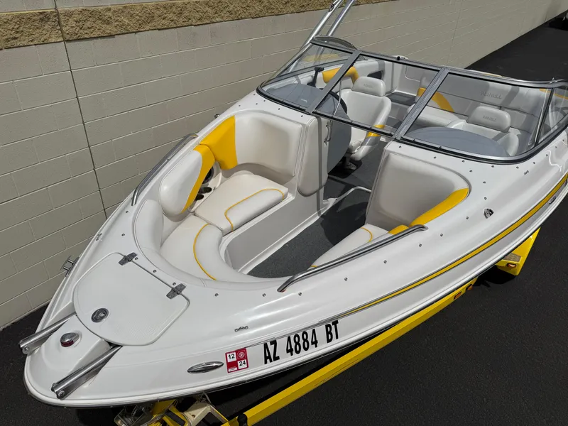 Slide: The Image of 2008 Reinell Bowrider 220LSE boat with yellow and white interior, docked on a trailer. - 8