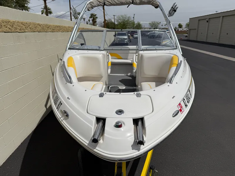 Slide: The Image of 2008 Reinell Bowrider 220LSE boat with yellow and white interior, parked outdoors. - 9