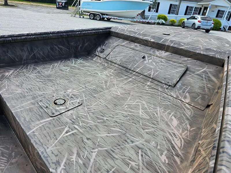 Slide: The Image of 2025 G3 Gator Tough 16 DK boat with camo interior, parked outdoors. - 11