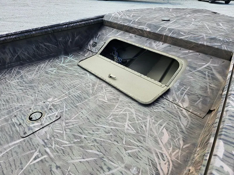 Slide: The Image of 2025 G3 Gator Tough 16 DK boat with open storage compartment, camo pattern. - 12