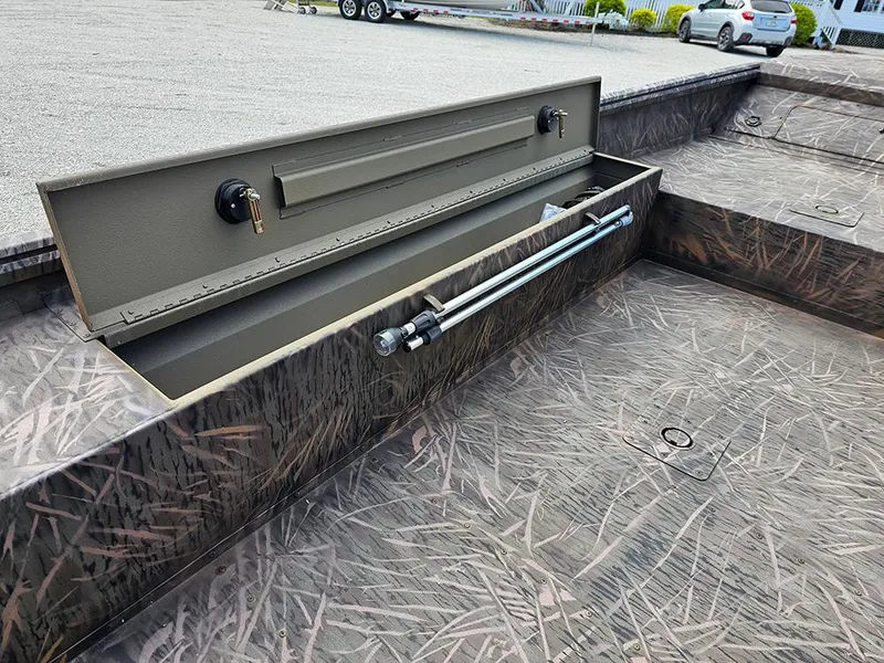 Slide: The Image of 2025 G3 Gator Tough 16 DK boat with open storage compartment, camo interior design. - 13