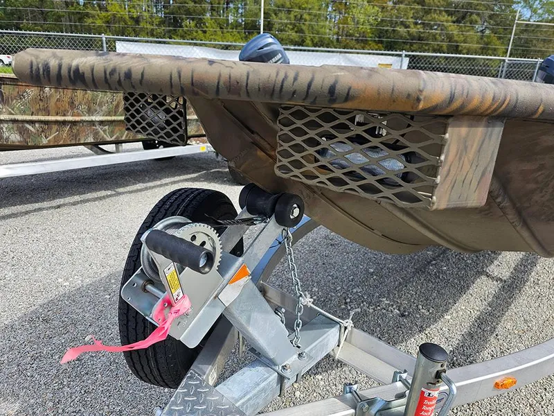 Slide: The Image of 2025 G3 Gator Tough 16 DK boat on trailer, featuring camouflage design and winch system. - 14