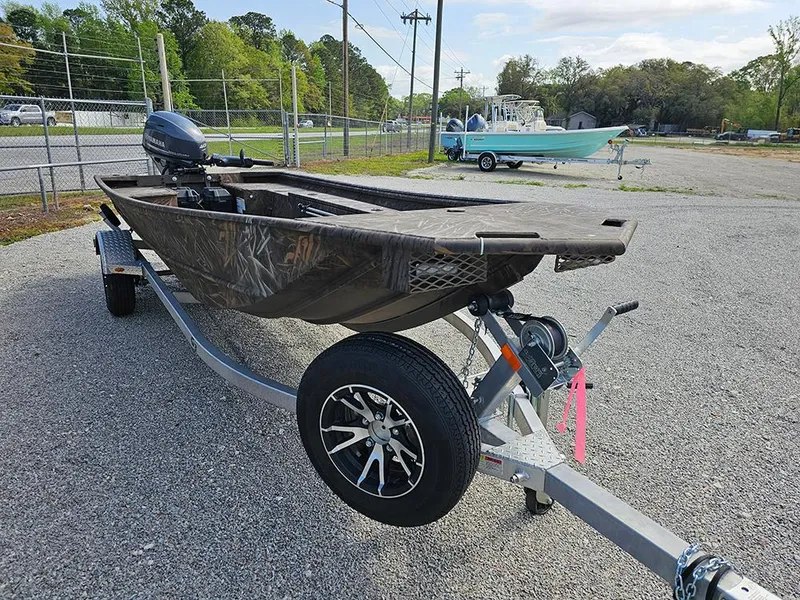 Slide: The Image of 2025 G3 Gator Tough 16 DK boat on trailer, parked outdoors. - 5