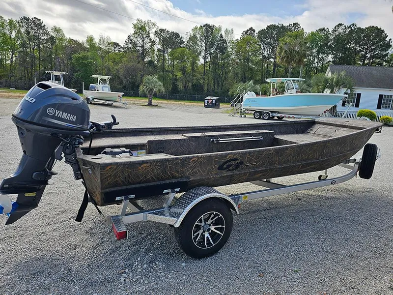 Slide: The Image of 2025 G3 Gator Tough 16 DK boat on trailer with Yamaha outboard motor, parked outdoors. - 7