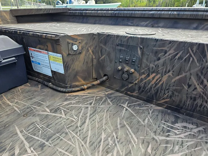 Slide: The Image of 2025 G3 Gator Tough 16 DK boat interior with camouflage design and control panel. - 9