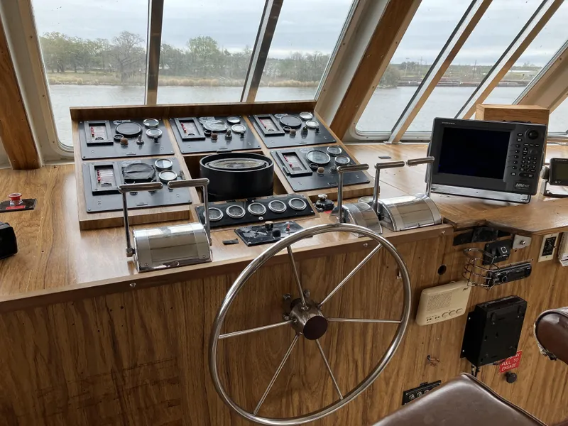 Slide: The Image of Bridge of a 1994 Commercial Offshore Crew Boat with navigation controls and steering wheel. - 2