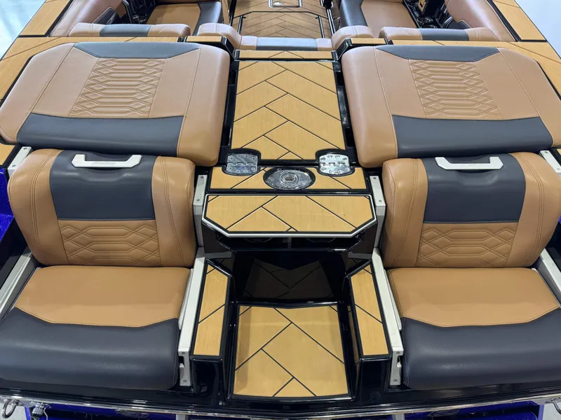 Slide: The Image of 2023 Malibu Wakesetter 26 LSV interior with tan and black seating, stylish design. - 10