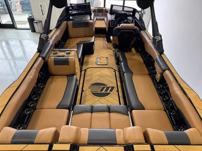 Slide: The Image of 2023 Malibu Wakesetter 26 LSV interior with luxurious tan and black seating. - 13