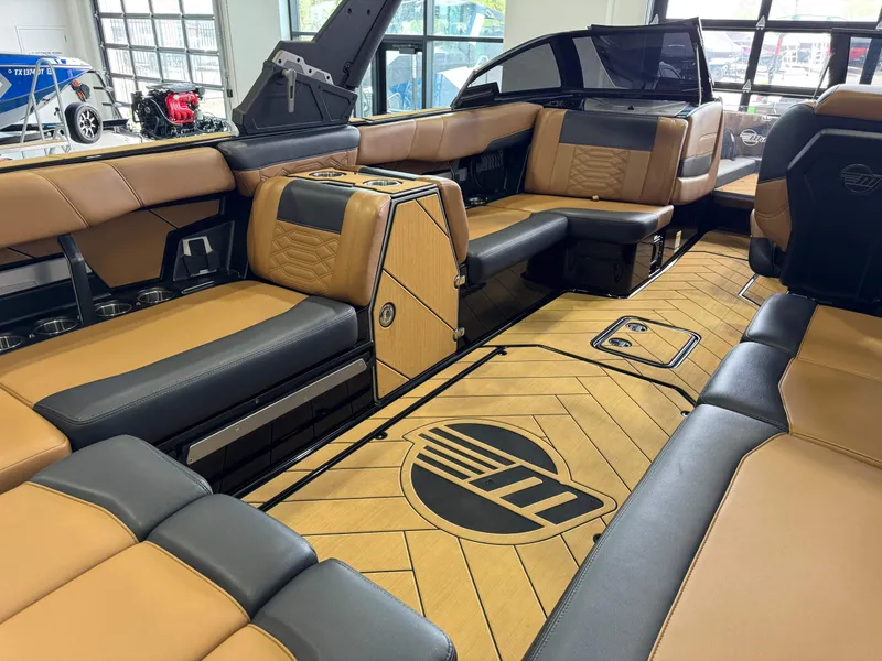 Slide: The Image of 2023 Malibu Wakesetter 26 LSV interior with luxurious tan and black seating. - 14