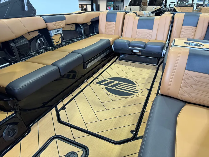 Slide: The Image of 2023 Malibu Wakesetter 26 LSV interior with tan and black seating, stylish flooring. - 15