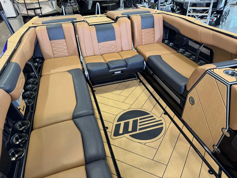 Slide: The Image of Luxurious interior of 2023 Malibu Wakesetter 26 LSV boat with tan and black seating. - 16
