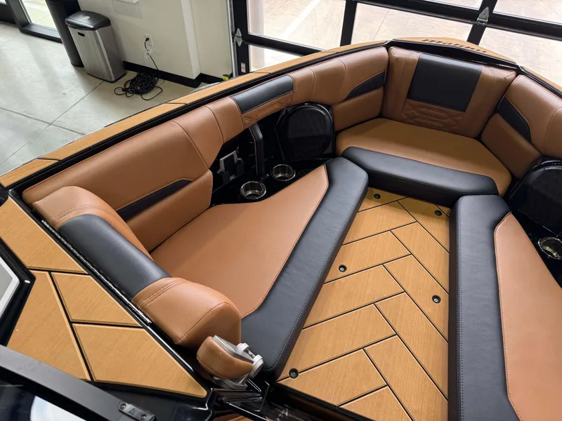 Slide: The Image of Luxurious interior of 2023 Malibu Wakesetter 26 LSV with tan and black seating. - 19