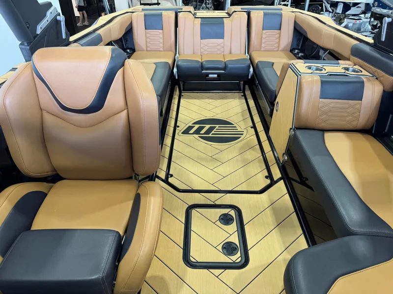 Slide: The Image of Luxurious interior of 2023 Malibu Wakesetter 26 LSV with tan and black seating. - 21