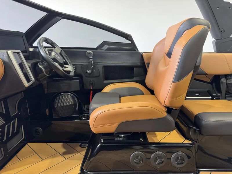 Slide: The Image of Interior of 2023 Malibu Wakesetter 26 LSV boat with tan and black seating. - 22