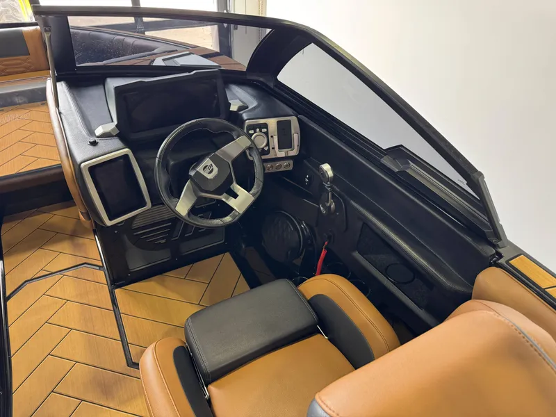 Slide: The Image of 2023 Malibu Wakesetter 26 LSV interior with modern dashboard and steering wheel. - 24