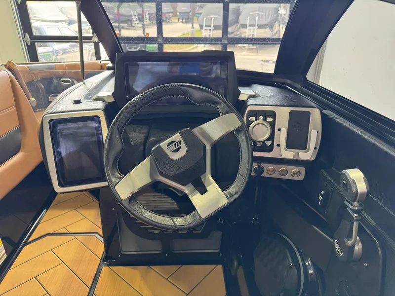 Slide: The Image of 2023 Malibu Wakesetter 26 LSV dashboard with modern steering and control panels. - 25
