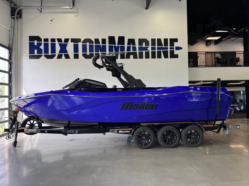 Slide: The Image of 2023 Malibu Wakesetter 26 LSV boat in vibrant blue at Buxton Marine showroom. - 4