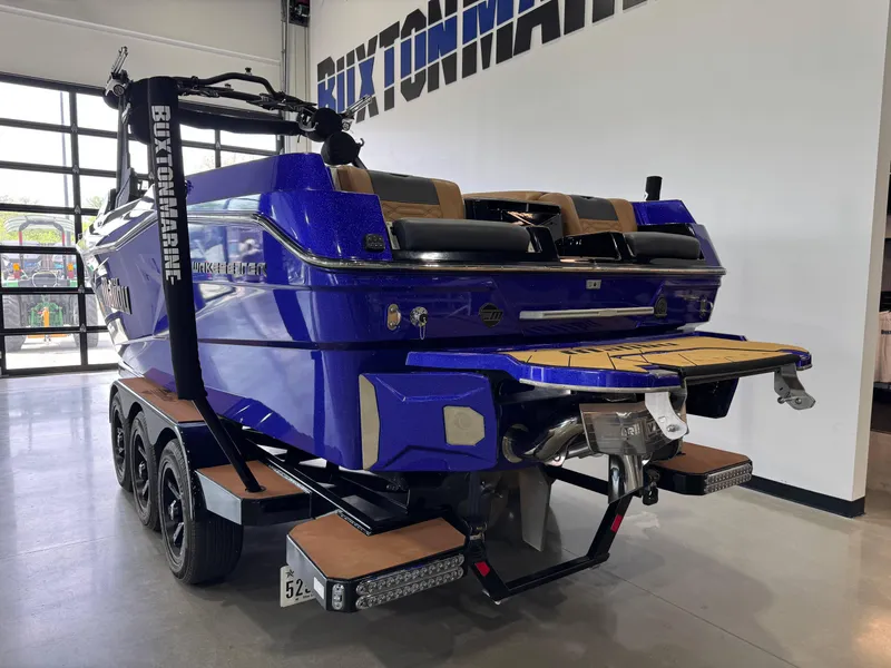 Slide: The Image of 2023 Malibu Wakesetter 26 LSV boat in showroom, vibrant blue finish, on trailer. - 5