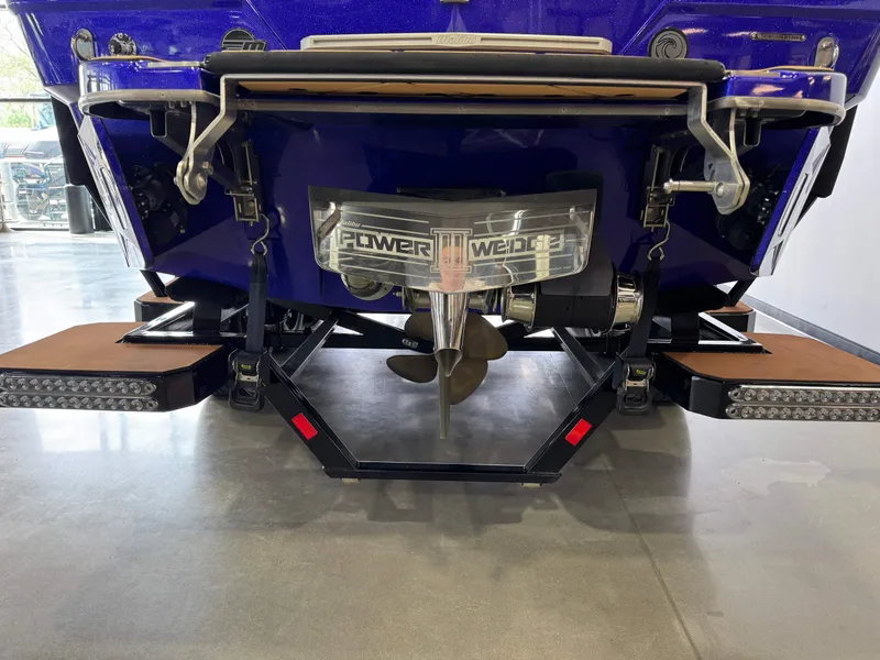 Slide: The Image of 2023 Malibu Wakesetter 26 LSV rear view showcasing propeller and swim platform. - 7