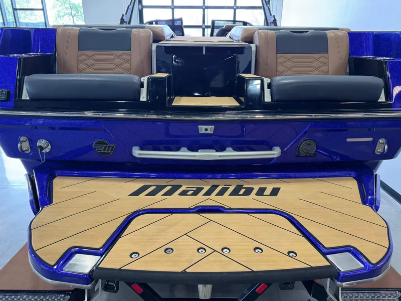 Slide: The Image of 2023 Malibu Wakesetter 26 LSV boat, rear view with luxury seating and teak swim platform. - 8