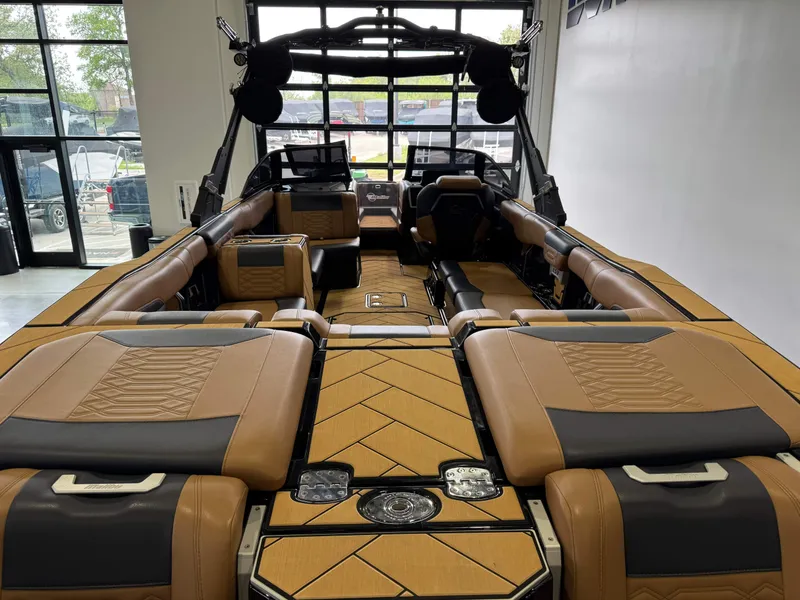 Slide: The Image of 2023 Malibu Wakesetter 26 LSV interior with luxurious tan and black seating. - 9