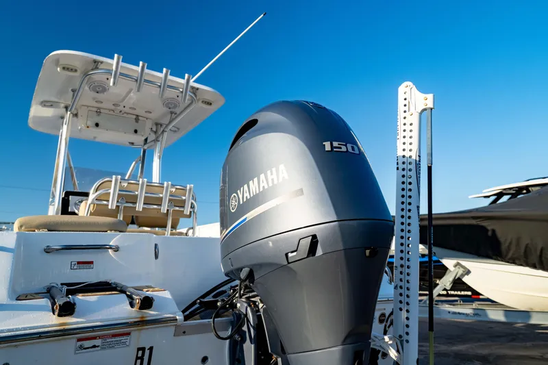 Slide: The Image of 2018 Sea Hunt Triton 210 boat with Yamaha 150 outboard motor under clear blue sky. - 11