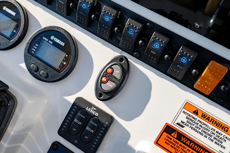 Slide: The Image of Control panel of a 2018 Sea Hunt Triton 210 boat with Yamaha gauges and warning labels. - 17