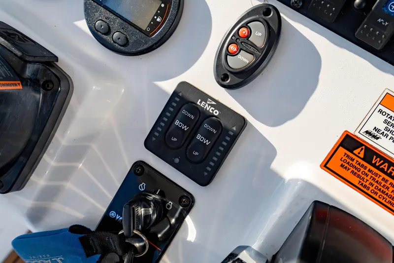 Slide: The Image of Control panel of a 2018 Sea Hunt Triton 210 boat with various switches and gauges. - 18