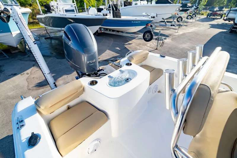 Slide: The Image of 2018 Sea Hunt Triton 210 boat with Yamaha 150 engine, featuring comfortable seating and fishing rod holders. - 2