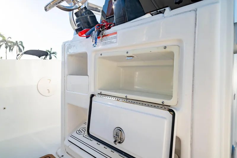 Slide: The Image of 2018 Sea Hunt Triton 210 boat storage compartment with open hatch and visible interior. - 22