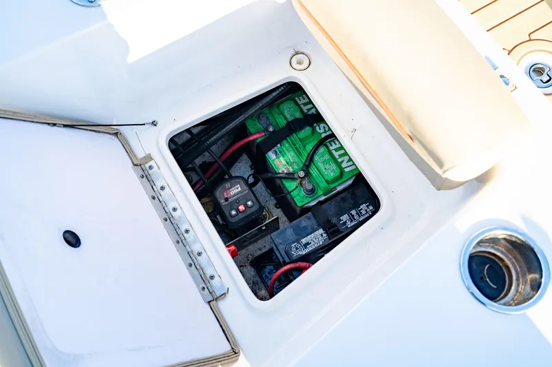Slide: The Image of Battery compartment of 2018 Sea Hunt Triton 210 boat, showing wiring and connections. - 25