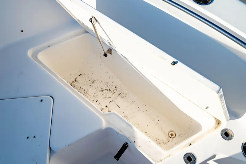 Slide: The Image of Open storage compartment on 2018 Sea Hunt Triton 210 boat, showing interior details. - 30