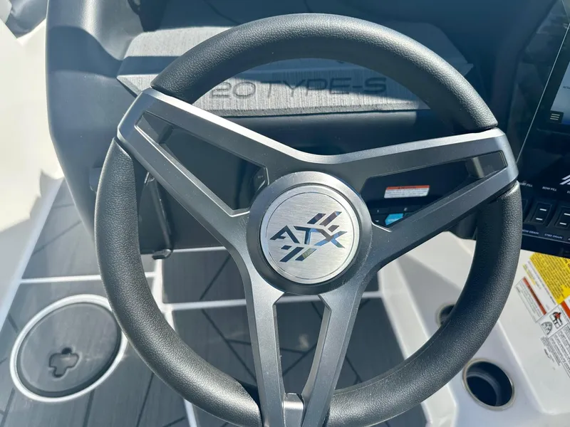 Slide: The Image of Steering wheel of 2024 ATX Surf Boats 20 Type-S, featuring sleek design and logo. - 12