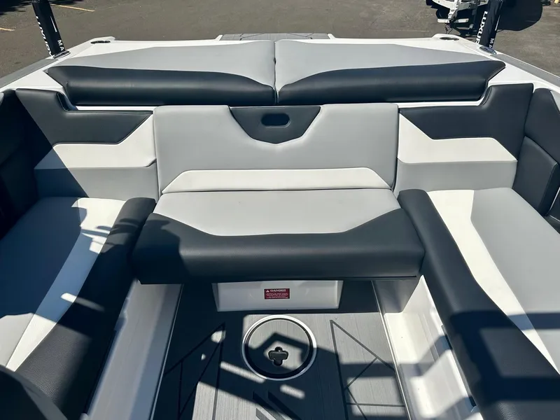 Slide: The Image of 2024 ATX Surf Boats 20 Type-S interior seating with black and gray upholstery. - 19