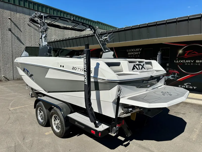 Slide: The Image of 2024 ATX Surf Boats 20 Type-S on trailer, displayed outdoors at a dealership. - 2