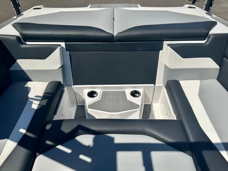 Slide: The Image of 2024 ATX Surf Boats 20 Type-S interior seating with cup holders, featuring sleek black and gray design. - 22