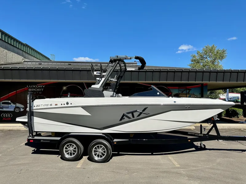 Slide: The Image of 2024 ATX Surf Boats 20 Type-S on trailer, parked outdoors under clear blue sky. - 26