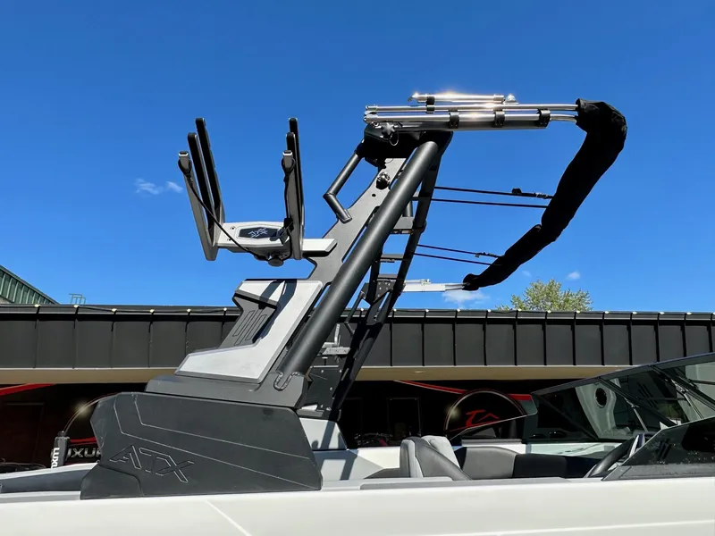 Slide: The Image of 2024 ATX Surf Boats 20 Type-S with sleek wakeboard tower against blue sky. - 35