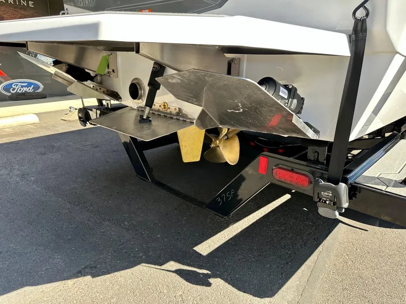 Slide: The Image of 2024 ATX Surf Boats 20 Type-S rear view, showcasing propeller and trailer details. - 36