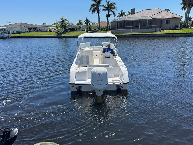 Slide: The Image of 2009 Edgewater 245 CX boat cruising on a sunny canal with palm trees. - 15