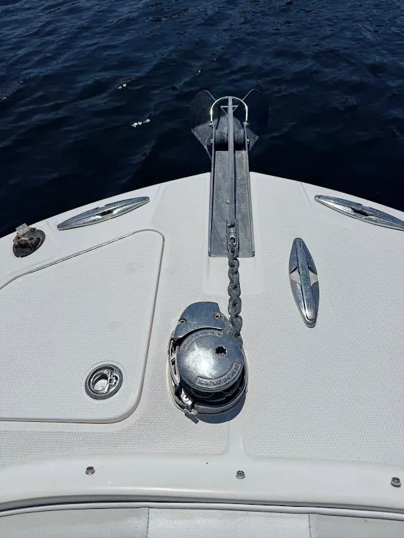 Slide: The Image of Bow of 2009 Edgewater 245 CX boat with anchor chain, on calm water. - 20